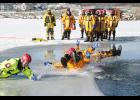 Photo by Dann Hayes Firefighters from Montezuma, Deep River, New Sharon and Malcom braved cold water as they learned rescue methods in ice using up-to-date equipment and techniques that provide maximum security to both the rescuer and the victim in the water. They trained on Lake Ponderosa on Jan. 19. In the photo above, firefighters had a little fun sliding on the ice. See more photos and story inside. Photo by Dann Hayes.